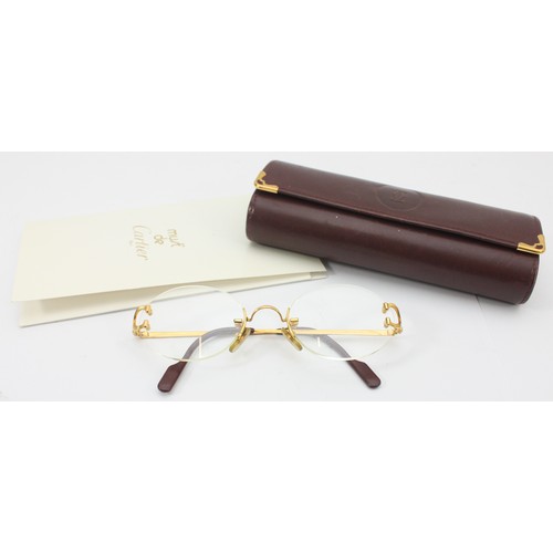 227 - Cartier; a pair of prescription rimless glasses, featuring oval shaped lenses with gold and burgundy... 