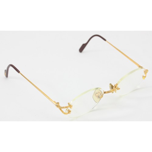 227 - Cartier; a pair of prescription rimless glasses, featuring oval shaped lenses with gold and burgundy... 