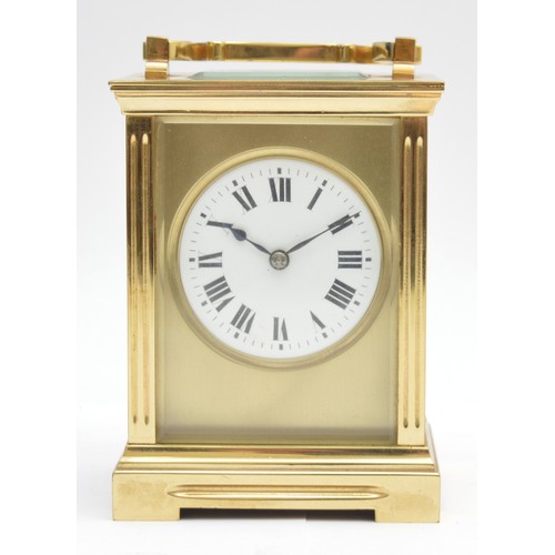 393 - A brass striking carriage clock, circular white enamel dial with Roman numerals, the eight day movem... 