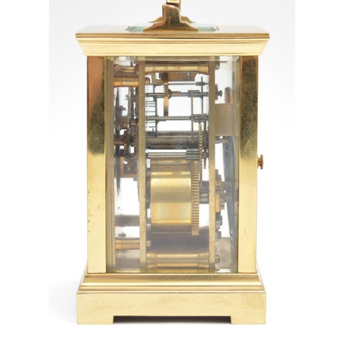 393 - A brass striking carriage clock, circular white enamel dial with Roman numerals, the eight day movem... 