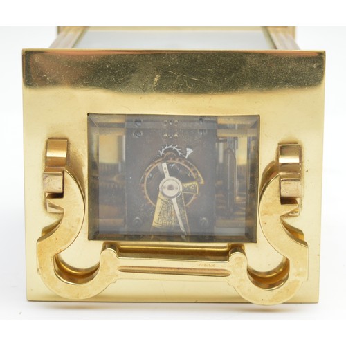 393 - A brass striking carriage clock, circular white enamel dial with Roman numerals, the eight day movem... 