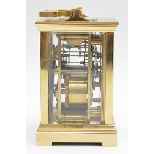 393 - A brass striking carriage clock, circular white enamel dial with Roman numerals, the eight day movem... 