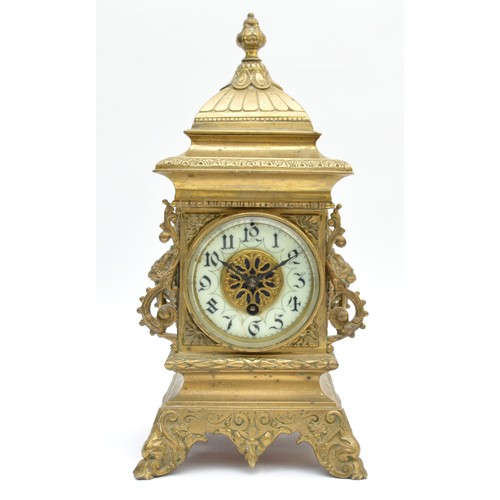 409 - A late 19th century French cast brass mantel timepiece, with lion mask handles, raised on scroll fee... 