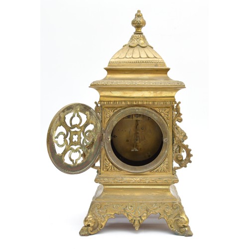 409 - A late 19th century French cast brass mantel timepiece, with lion mask handles, raised on scroll fee... 