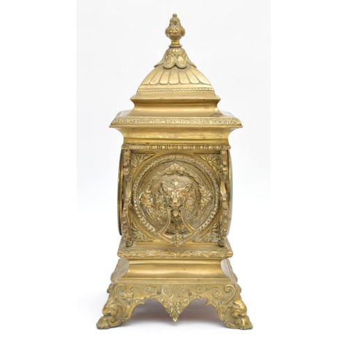409 - A late 19th century French cast brass mantel timepiece, with lion mask handles, raised on scroll fee... 
