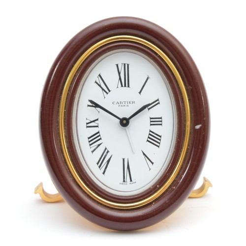 418 - Cartier, an oval brass and brown resin alarm clock, serial number 7509 20795, 9cm.
Not working, main... 