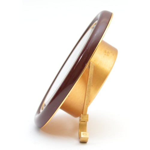418 - Cartier, an oval brass and brown resin alarm clock, serial number 7509 20795, 9cm.
Not working, main... 