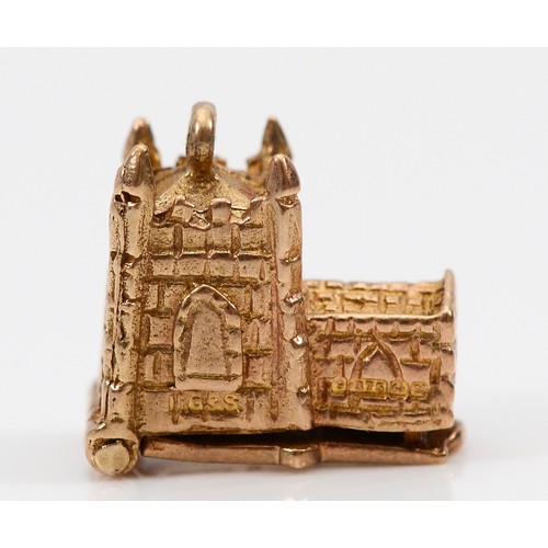 A 9ct gold charm in the form of a church, opens to reveal a bride and groom, hallmarks worn, 15mm, 4.3g