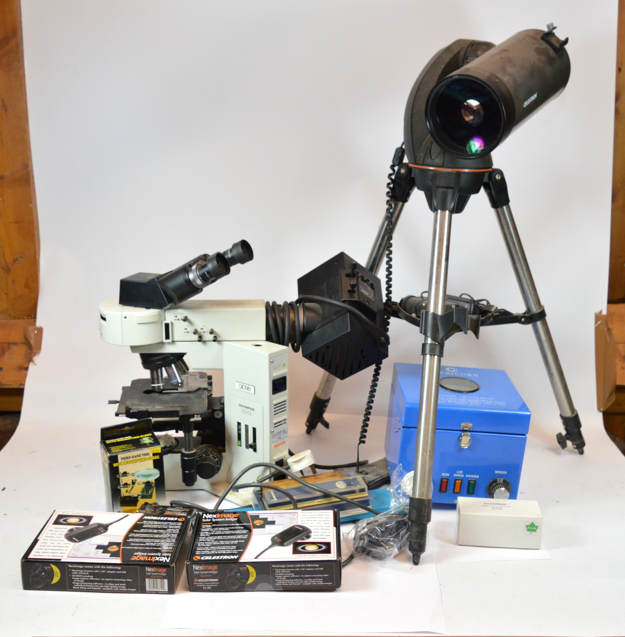 Three scientific instruments, an Olympus BX40F biological microscope, a ...