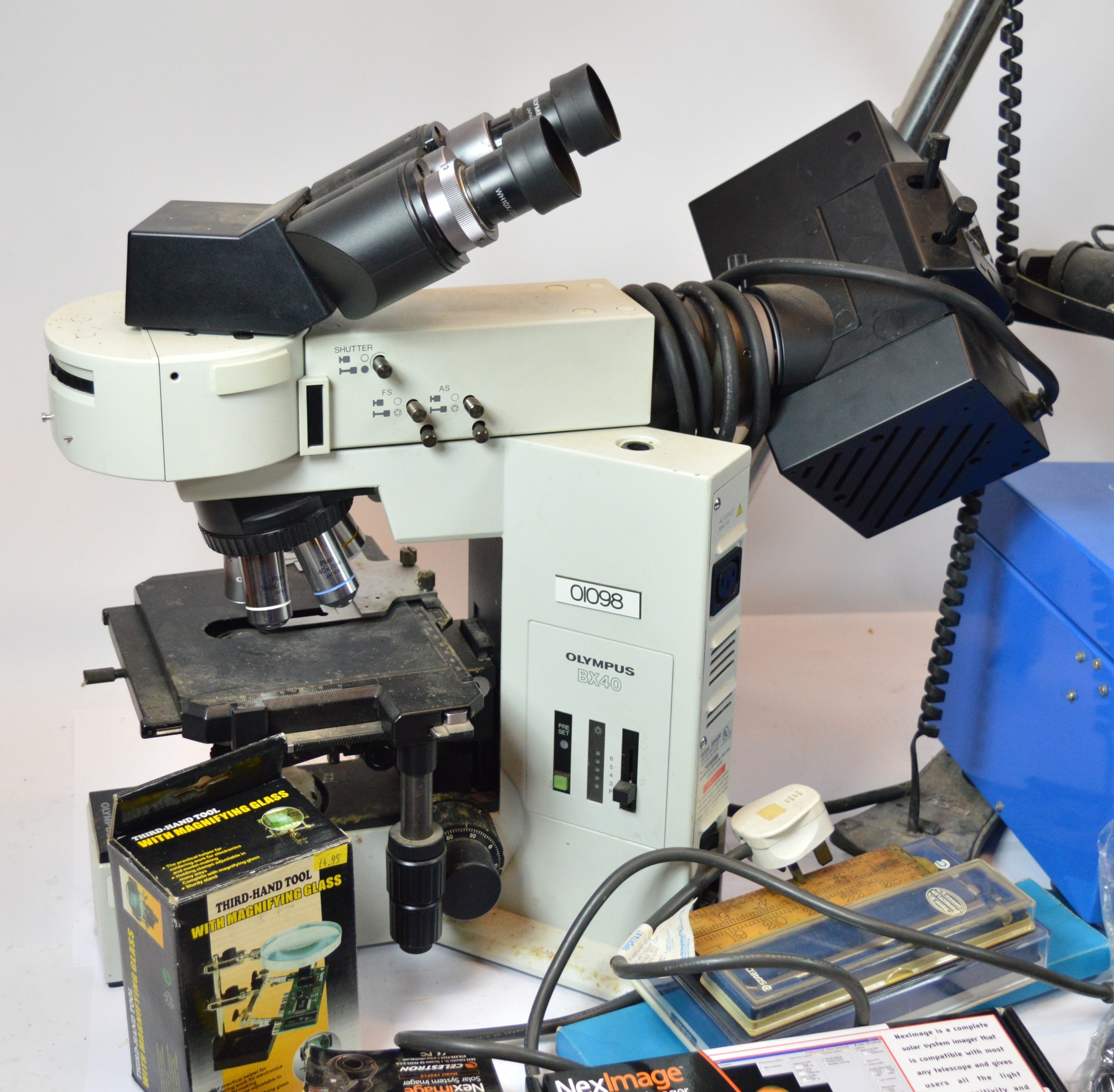 Three scientific instruments, an Olympus BX40F biological microscope, a ...