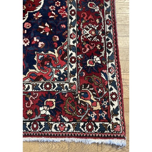A large Persian Bakhtiar wool rug, having central concentric medallion ...