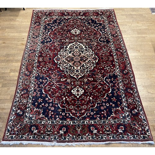 A large Persian Bakhtiar wool rug, having central concentric medallion ...