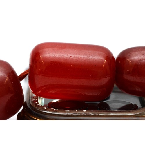 16 - A cherry Bakelite beaded necklace, graduated beads, largest 25mm, screw closure, 92cm, 90g