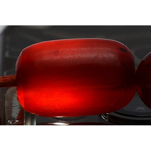 16 - A cherry Bakelite beaded necklace, graduated beads, largest 25mm, screw closure, 92cm, 90g