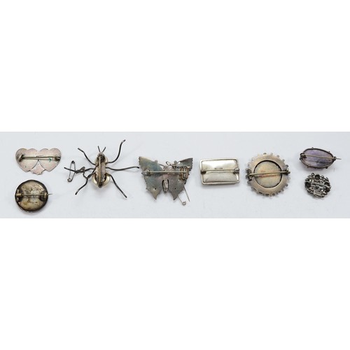 21 - Four Victorian silver brooches, a silver insect brooch, a silver and enamel floral brooch, a silver ... 