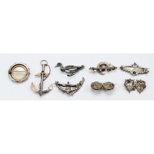 23 - Five Victorian silver brooches, two Edwardian silver brooches, Birmingham 1902 and 1904, and a 935 s... 