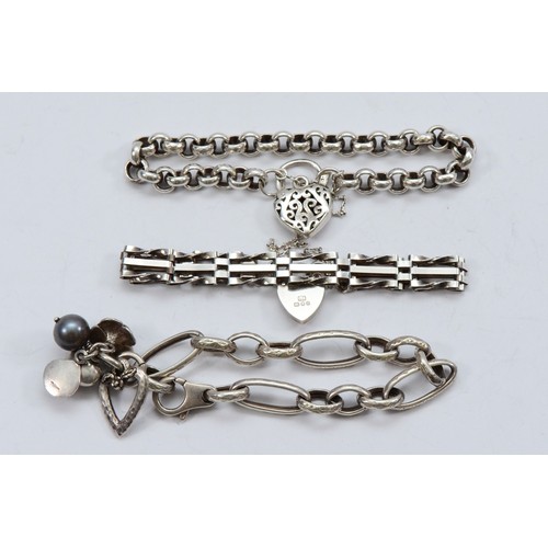 59 - A silver gate link bracelet with heart shaped padlock clasp, London 1978, a silver floral bracelet, ... 