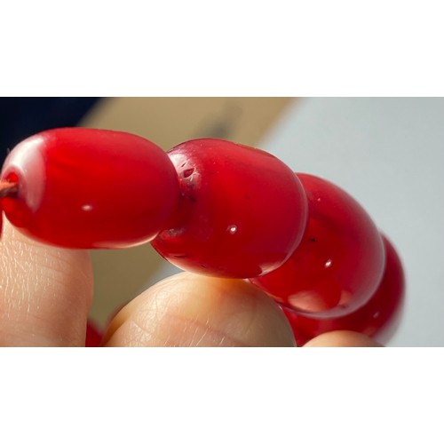 16 - A cherry Bakelite beaded necklace, graduated beads, largest 25mm, screw closure, 92cm, 90g