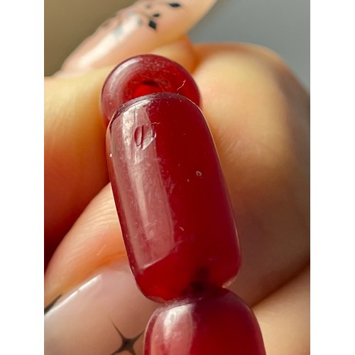 16 - A cherry Bakelite beaded necklace, graduated beads, largest 25mm, screw closure, 92cm, 90g