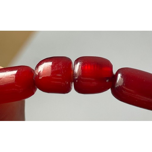 16 - A cherry Bakelite beaded necklace, graduated beads, largest 25mm, screw closure, 92cm, 90g