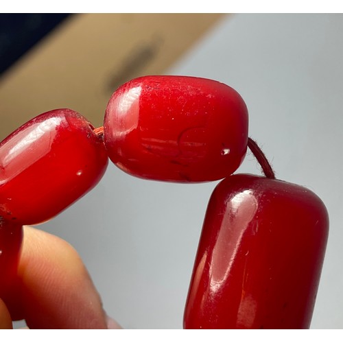 16 - A cherry Bakelite beaded necklace, graduated beads, largest 25mm, screw closure, 92cm, 90g