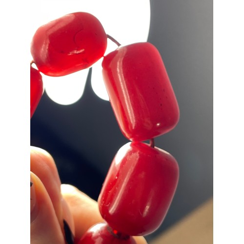 16 - A cherry Bakelite beaded necklace, graduated beads, largest 25mm, screw closure, 92cm, 90g
