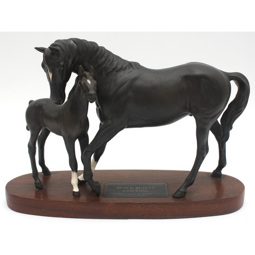 Beswick England; A connoisseur model of Black Beauty and foal, on a wooden plinth, matt finish, H20, W29cm.