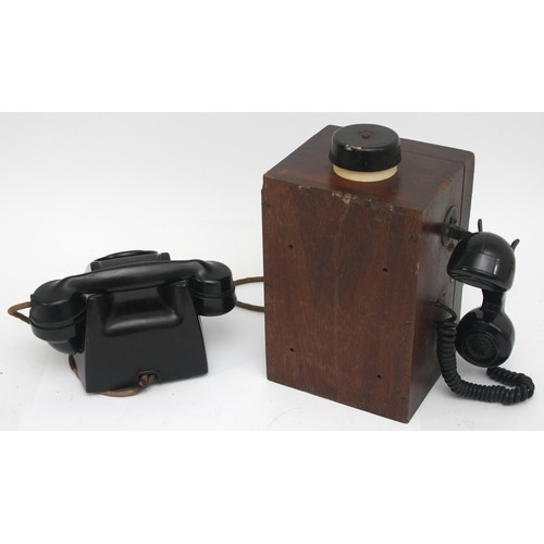 21 - A wooden cased signal box shelf telephone and a black Bakelite internal office telephone- both with ... 