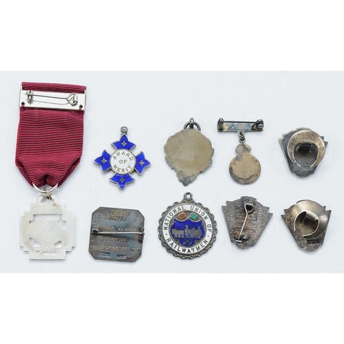 30 - A group of nine transport/railway and other silver and enamelled lapel badges and medals, to include... 