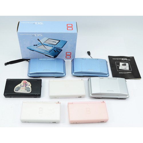 Three Nintendo DS handheld games consoles, together with four Nintendo ...