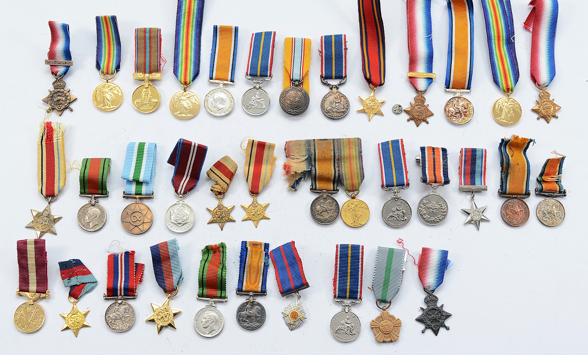A collection of miniature medals to include the Mons Star, Victory, War ...