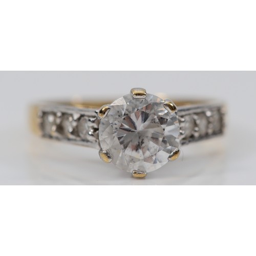 123 - A 9ct gold cubic zirconia solitaire ring with cubic zirconia set shoulders, N 1/2, 3g