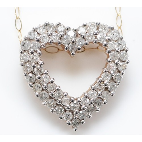 137 - A 9ct gold brilliant cut diamond heart shaped pendant on a chain, 18mm, 3.2g