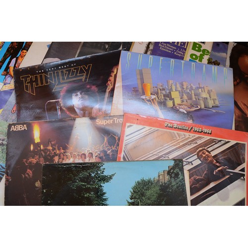 51 - A collection of 55 pop vinyl LP's to include artists, The Beatles, The Bee Gees, Stevie Wonder, Gene... 