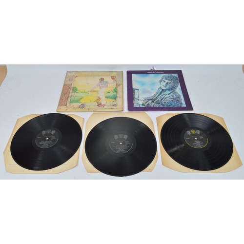 52 - A collection of twelve vinyl LP's to include artists, Queen, Guns n' roses, Elton John and Genesis, ... 