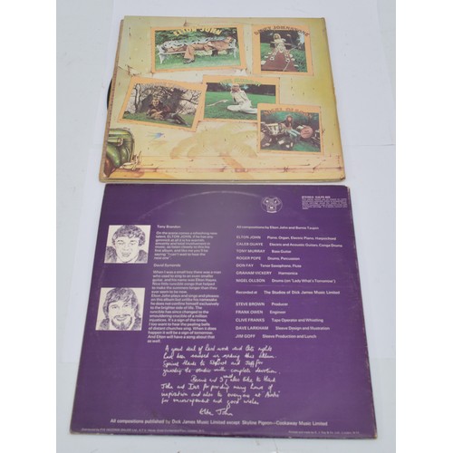 52 - A collection of twelve vinyl LP's to include artists, Queen, Guns n' roses, Elton John and Genesis, ... 