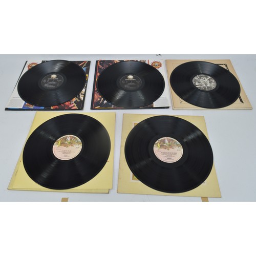 52 - A collection of twelve vinyl LP's to include artists, Queen, Guns n' roses, Elton John and Genesis, ... 