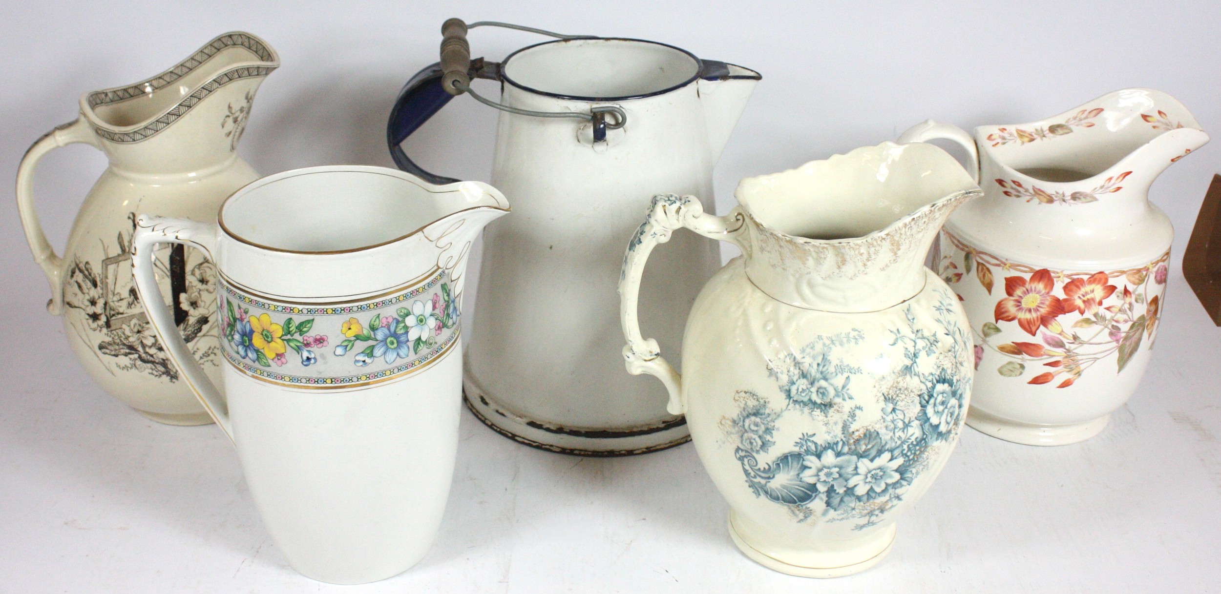 Five large pitchers, to include, rustic white enamel pitcher, possibly ...