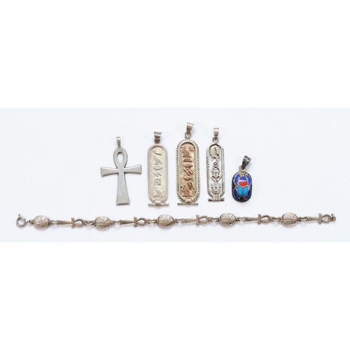 69 - Four Egyptian silver pendants, an Egyptian silver bracelet and a silver pendant, 40g