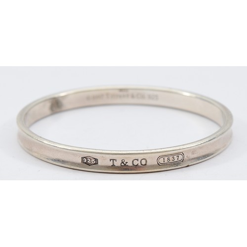 71 - Tiffany & Co, a silver concave bangle, London 2006, 65mm, 32g