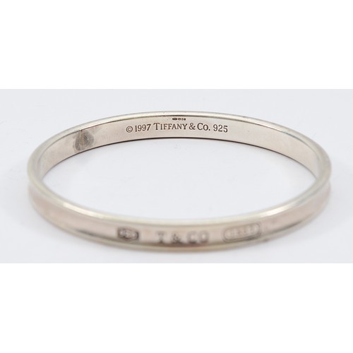 71 - Tiffany & Co, a silver concave bangle, London 2006, 65mm, 32g