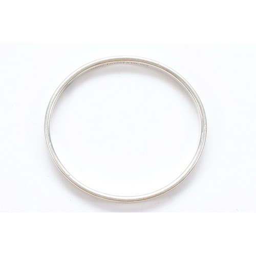71 - Tiffany & Co, a silver concave bangle, London 2006, 65mm, 32g