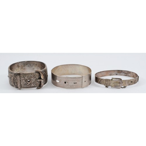94 - A silver buckle bangle, Chester 1941, a silver buckle bangle with safety chain, Birmingham 1976, and... 