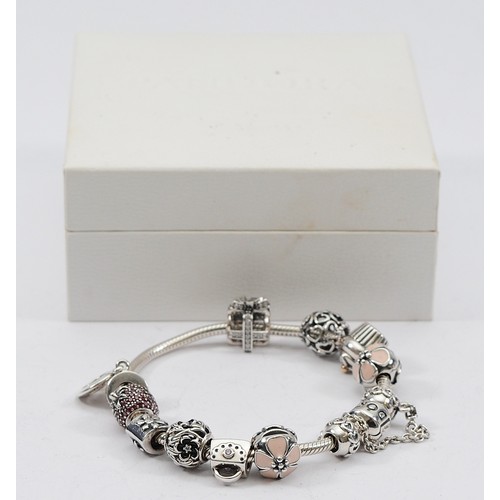 113 - Pandora, a silver charm bracelet with eleven charms, 46g
All have the 925 ALE hallmark