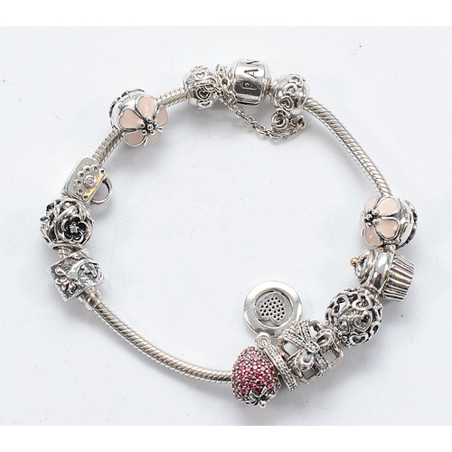 113 - Pandora, a silver charm bracelet with eleven charms, 46g
All have the 925 ALE hallmark