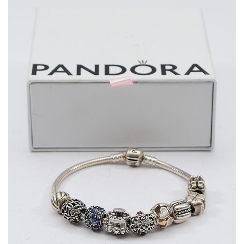 114 - Pandora, a silver charm bracelet with nine charms, 40g
All have the 925 ALE hallmark
