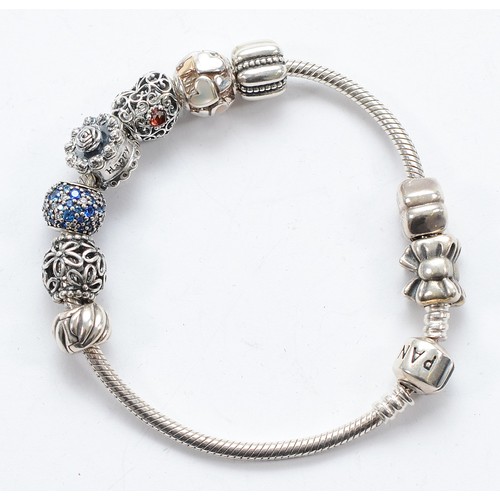 114 - Pandora, a silver charm bracelet with nine charms, 40g
All have the 925 ALE hallmark