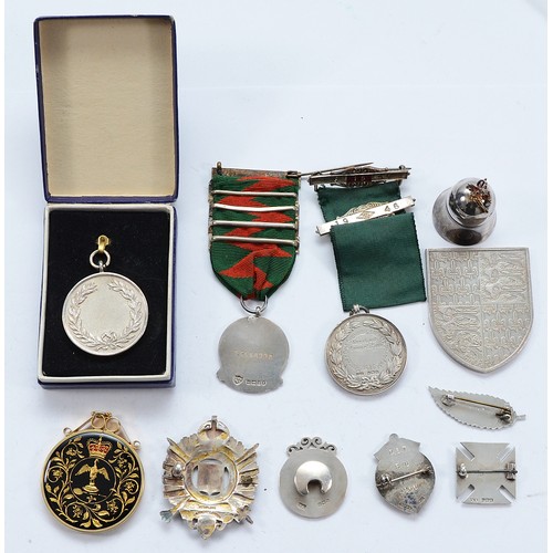 212 - Ten various silver medals and badges, together with a silver pill box, various dates, approximately ... 