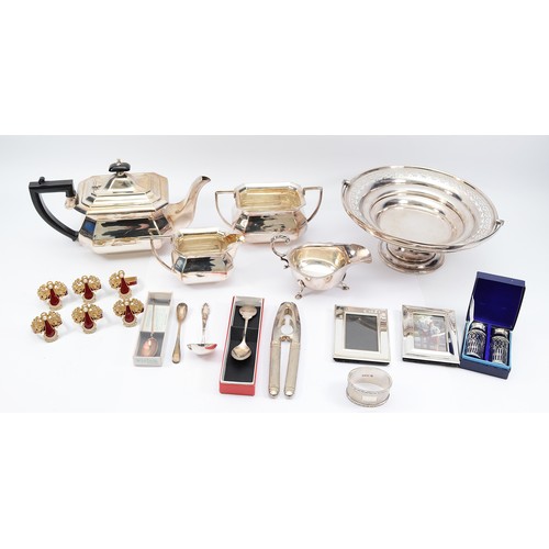 223 - A silver oval napkin ring, Sheffield 1969, 46gm, together with a three piece tea set, compromising o... 