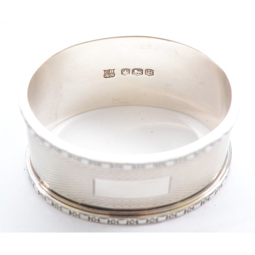 223 - A silver oval napkin ring, Sheffield 1969, 46gm, together with a three piece tea set, compromising o... 